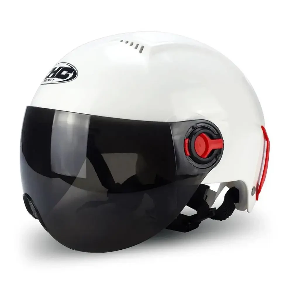 Un casque de moto blanc avec une visière noire intégrée et un bouton de réglage rouge