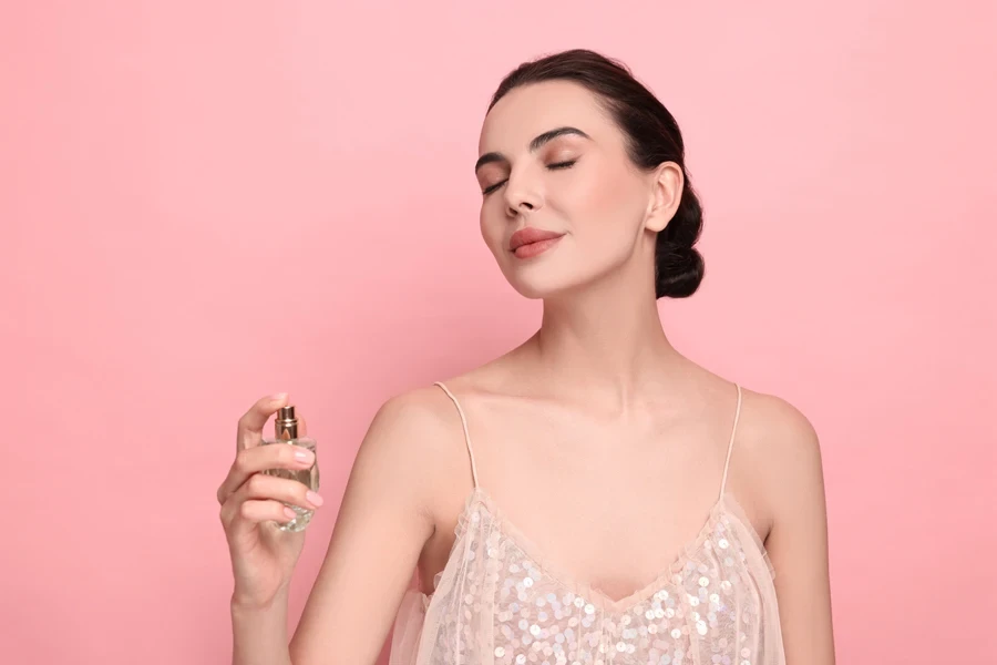 A woman spraying perfume