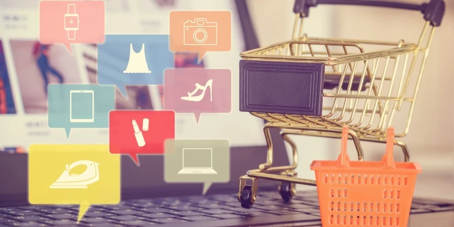Shopping cart and a plastic basket on a laptop computer keyboard