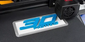 A 3D printer printing a blue logo