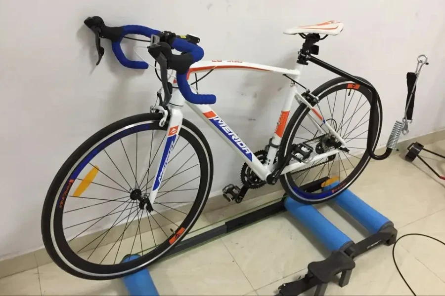 A bike rests on bike rollers for balance training