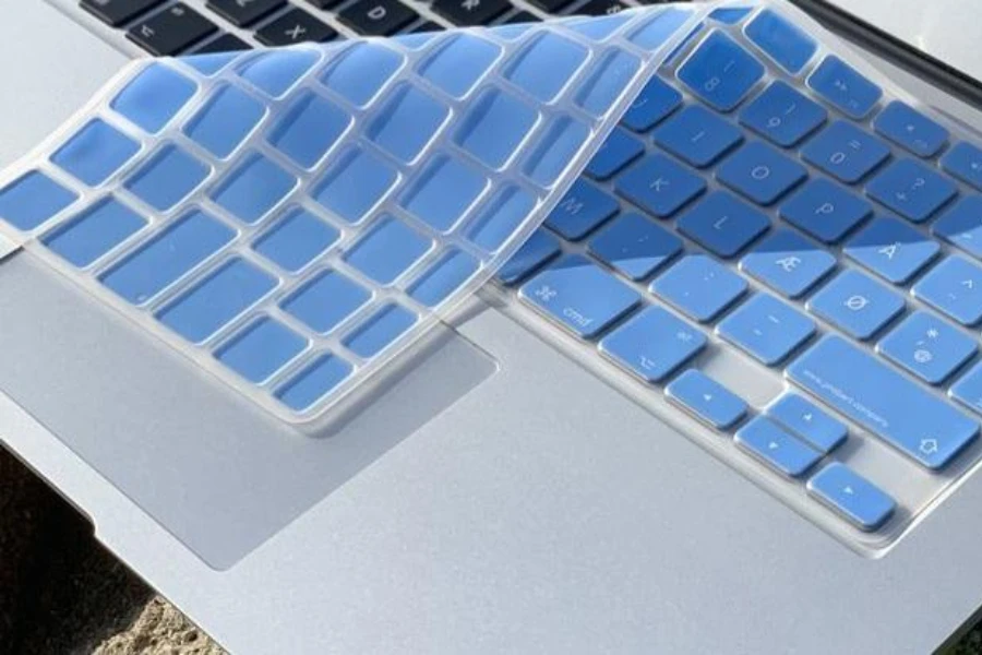 A blue keyboard cover placed on a laptop