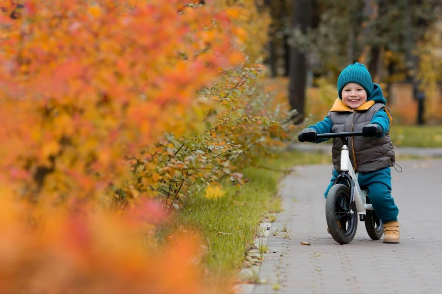 a boy riding a balance bike
