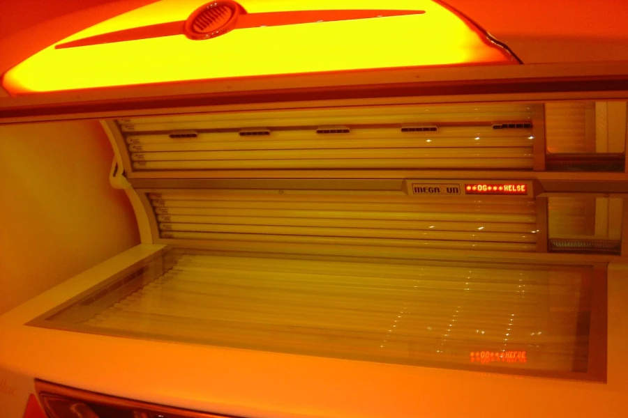 A commercial tanning bed with orange lighting