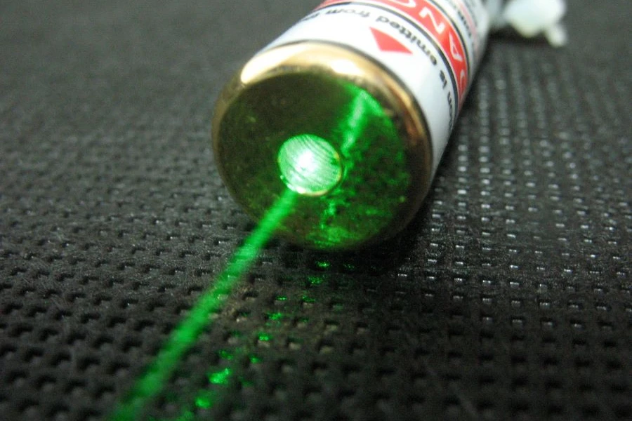 A green laser pointer on gray surface