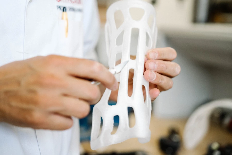 A person holding a 3D-printed, custom-made orthoses