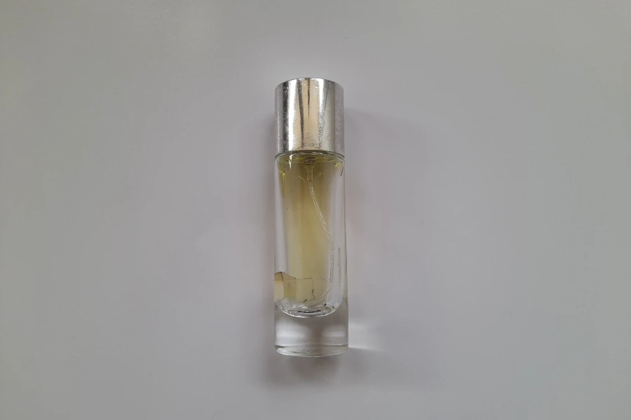 A refillable perfume bottle with a white background