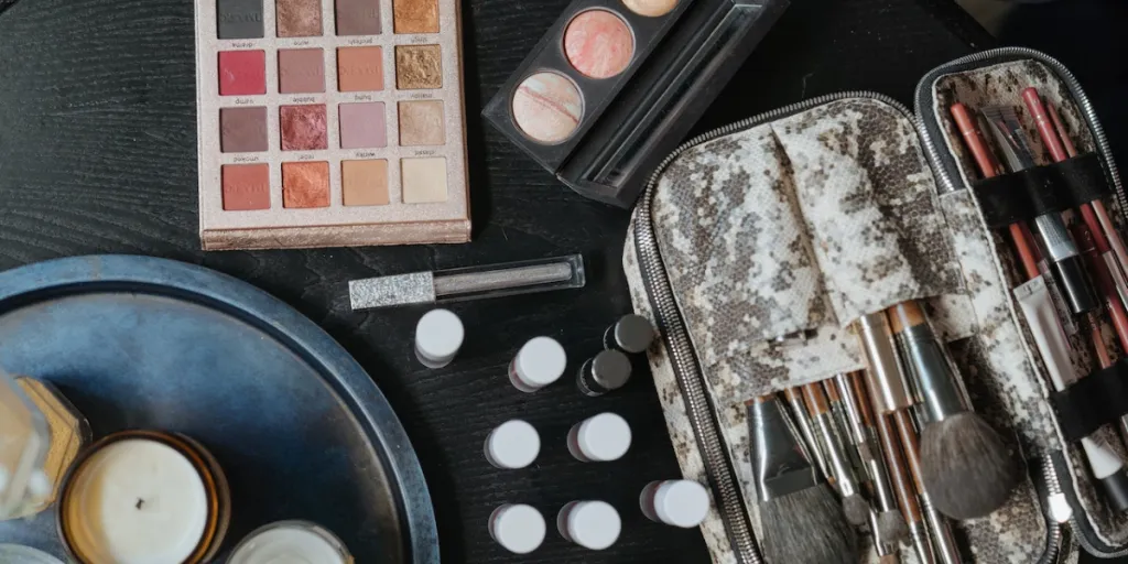 Different makeup products in a kit on a black table