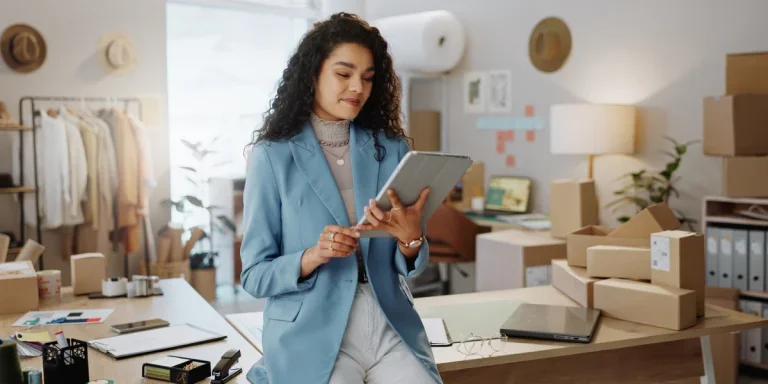 Happy business owner using a tablet
