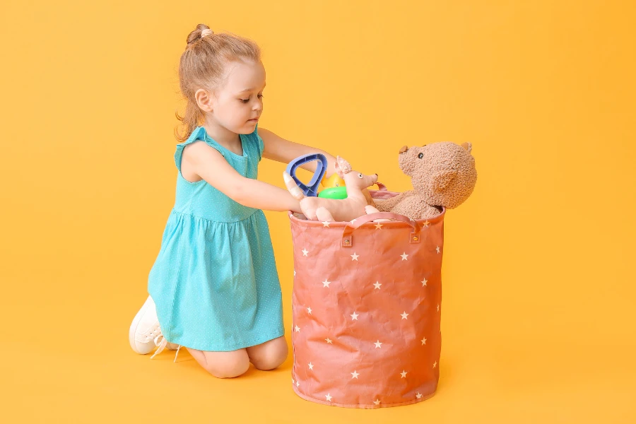 Little girl with a toy storage basket