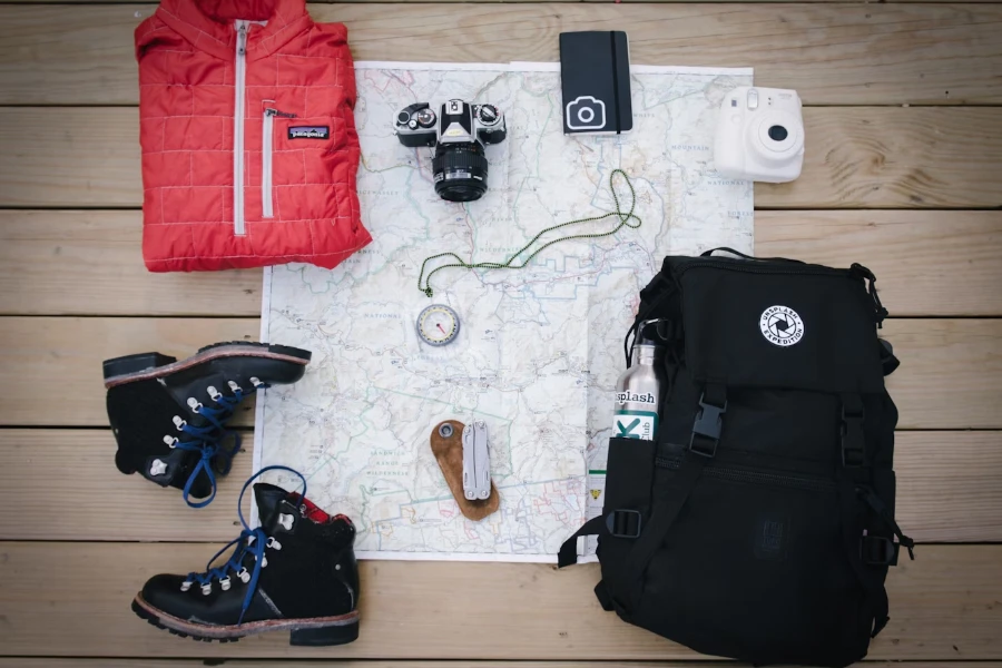 Map on floor surrounded by types of hiking equipment