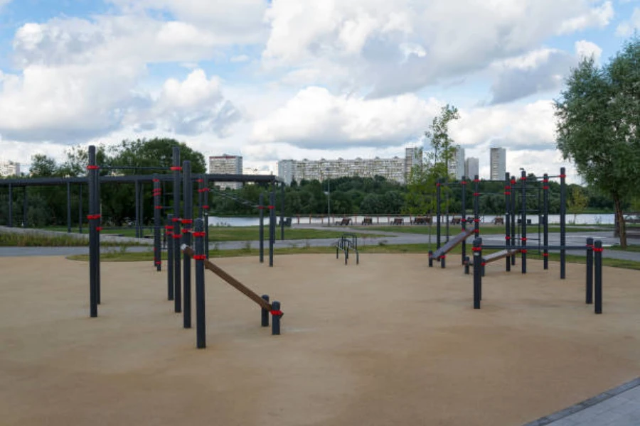 Outdoor workout stations in park setting under cloudy sky