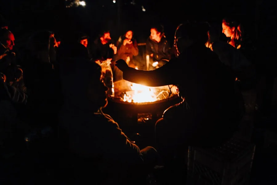 People surrounding an outdoor fire pit