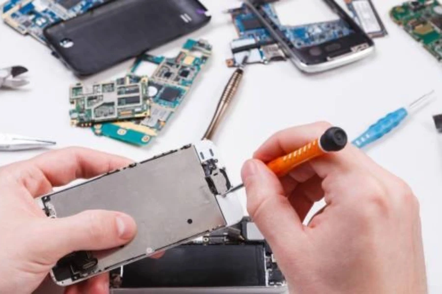 Repairman reassembling a phone after repairs