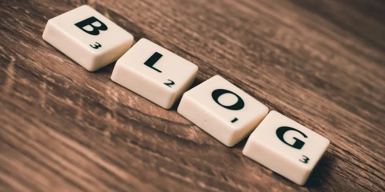 Scrabble letters that spell out blog sitting on a wooden table