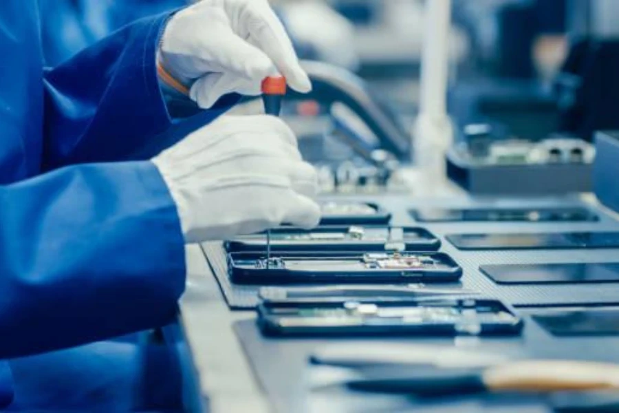 Technician repairing multiple phone screens