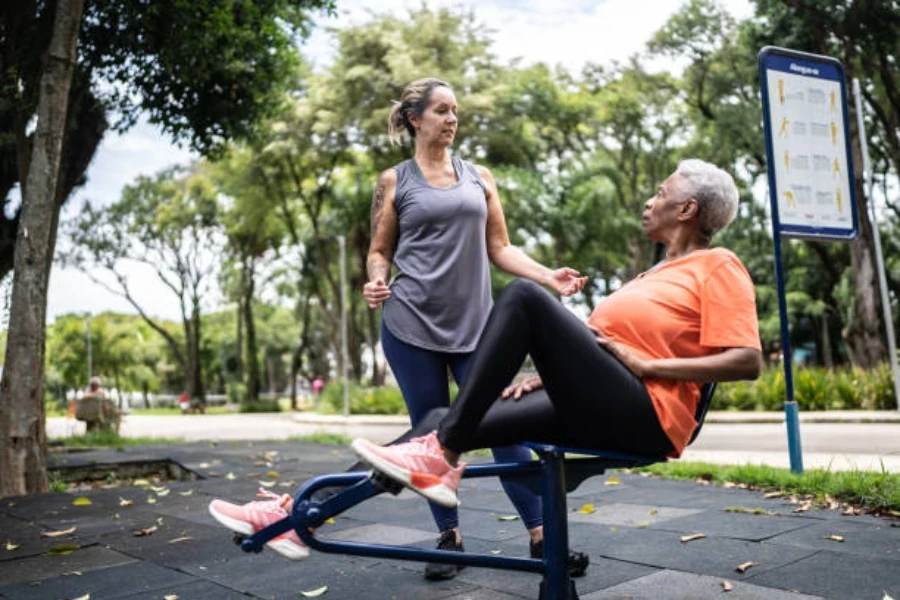 Two women speaking at an outdoor gym in autumn