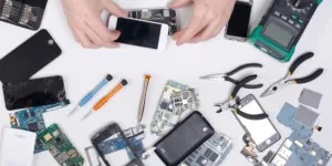 Various mobile phone replacement parts on a white table