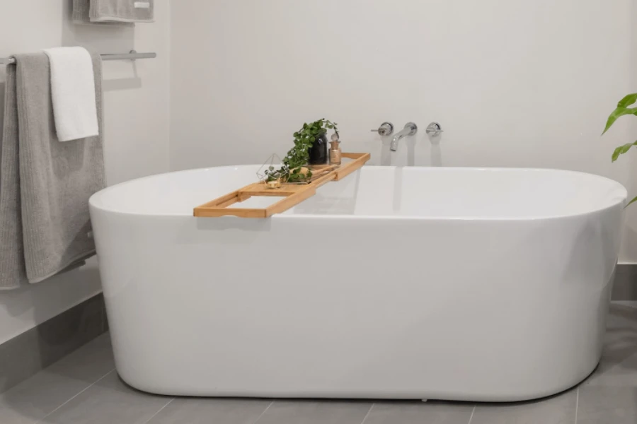 White soaking tub with bamboo bathtub tray