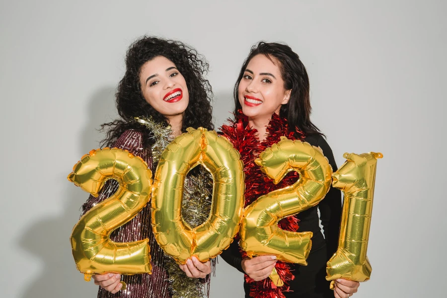 Women holding New Year balloons