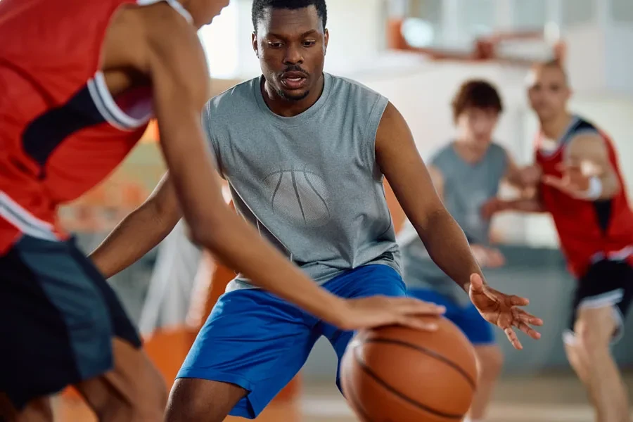Amateur men’s basketball game being played on indoor site