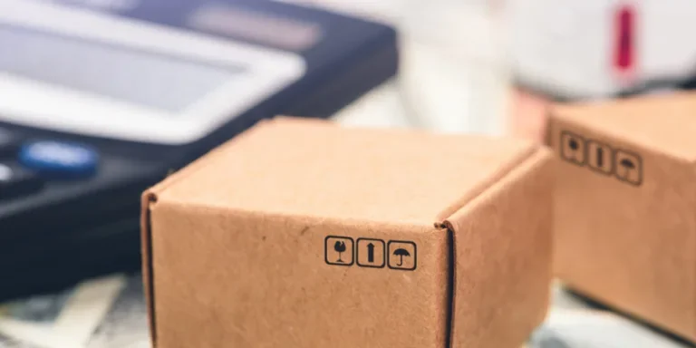 Calculator, lorry, airplane, cardboard boxes on a money background