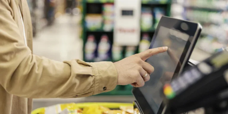 Close up of a man at self-service checkout at marketplace
