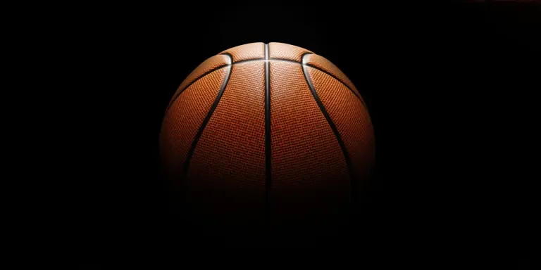 Close up of orange basketball with black background