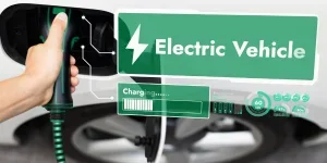 Electric car plugged in with charging station to recharge battery