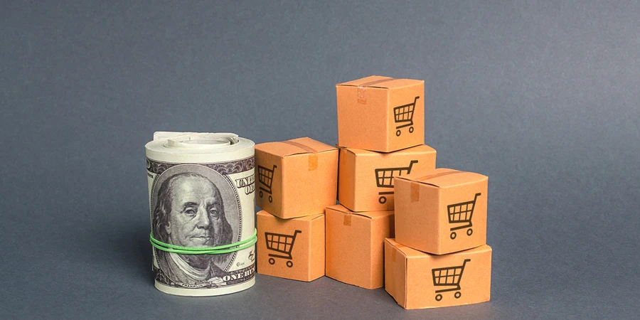 Roll bundle of dollars and cardboard boxes