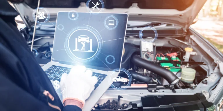 The abstract image of mechanic point to the hologram on his computer and blurred car engine room is backdrop
