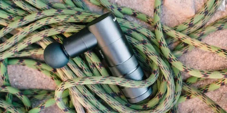 A handheld massager on some ropes