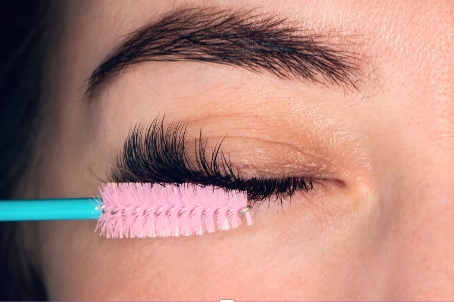 A lady with a gel pad and lash tape