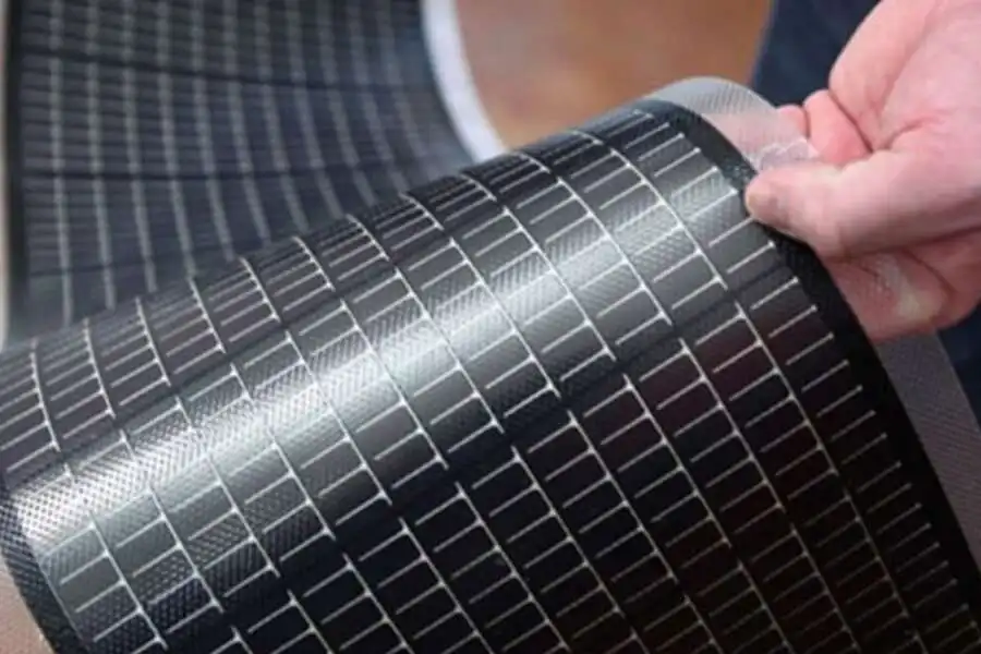 A person holding a thin-film solar panel