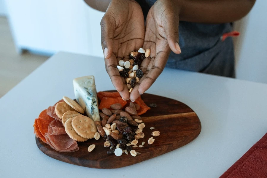 A person preparing a food platter