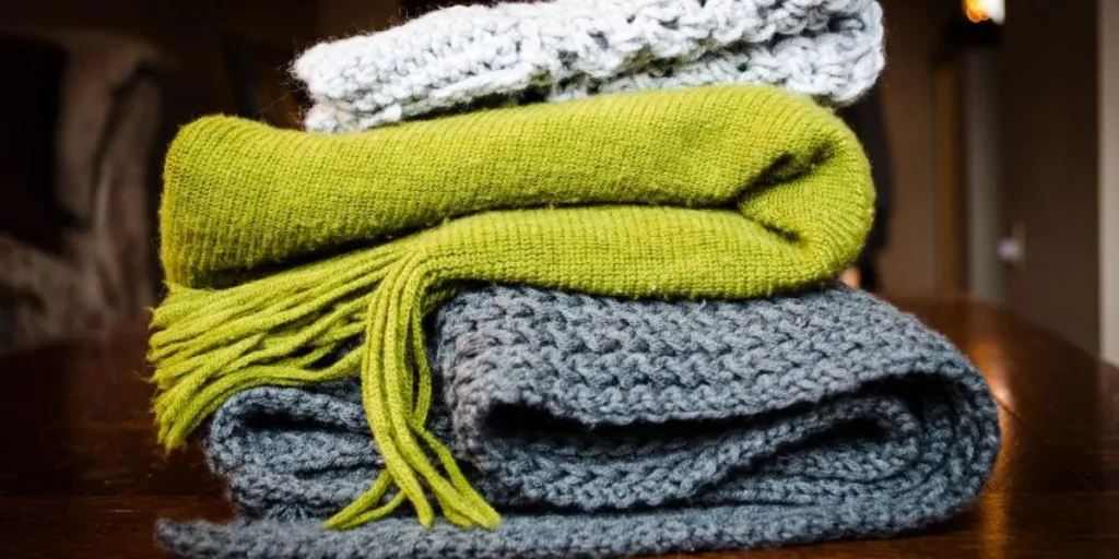 A stack of knitted throws and blankets