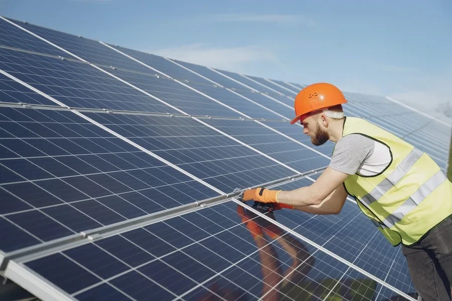 A technician installing solar roofs