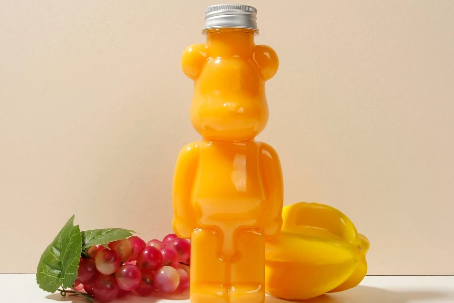 A transparent juice bottle crafted in the playful bear-shaped