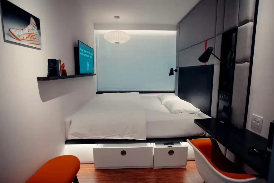 A white bed with storage drawers