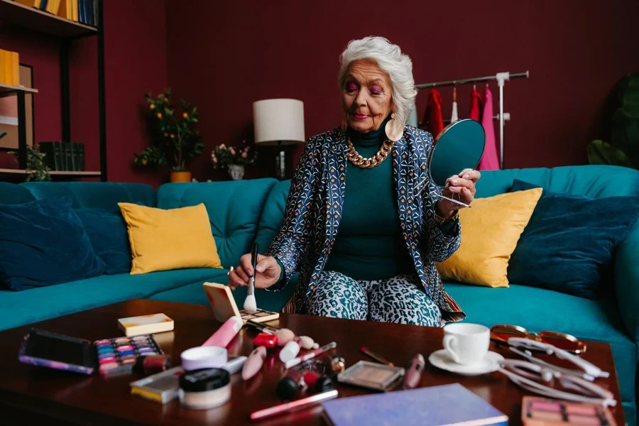 an old woman applying makeup