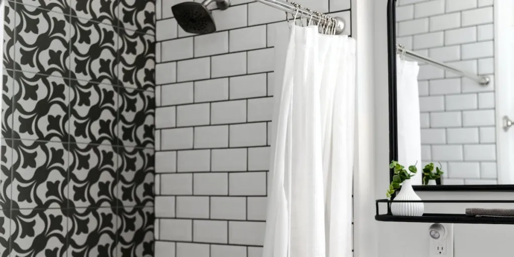 bathroom with a white shower curtain with hooks