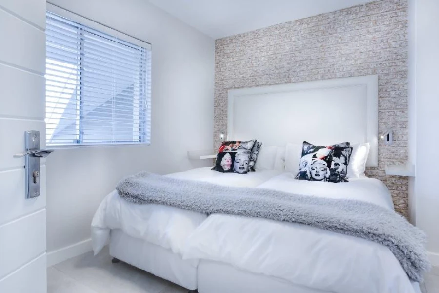 Schlafzimmer mit übergroßer Tagesdecke aus grauem Fell