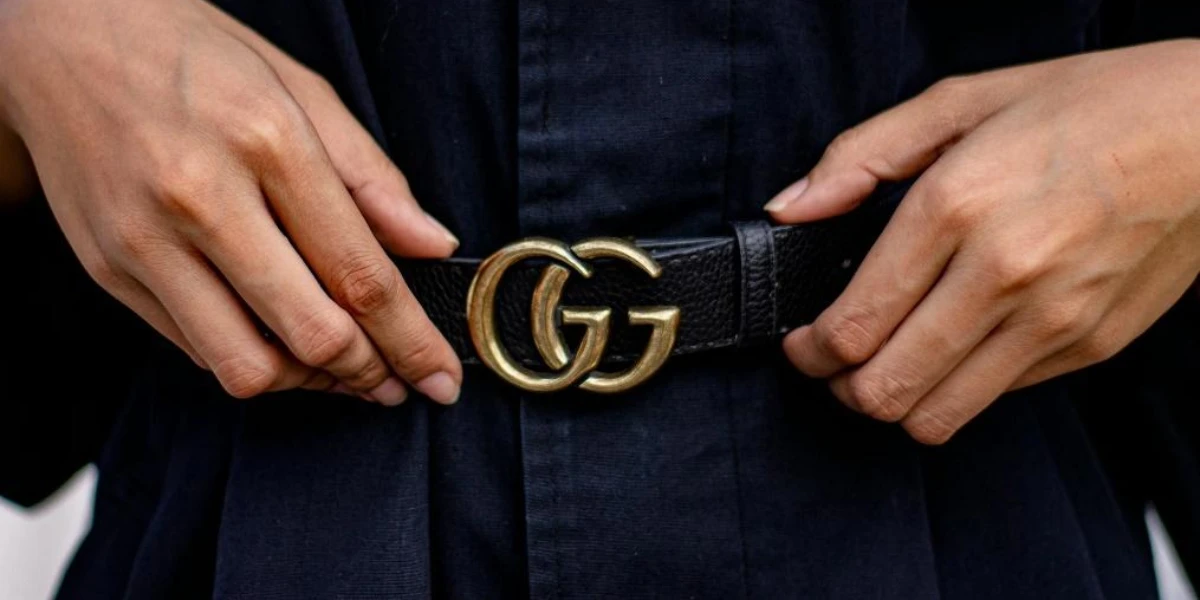 Black leather belt with gold monogram buckle