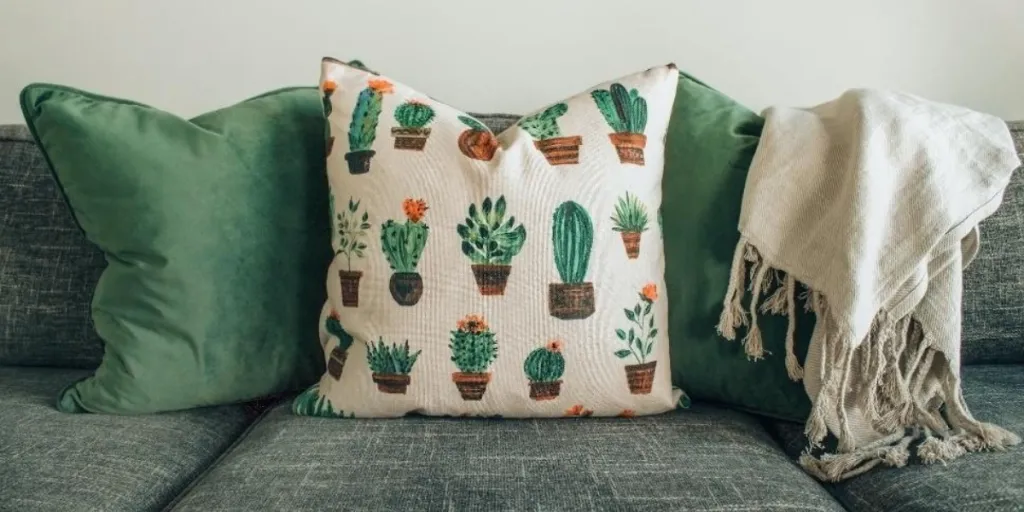 Couch with green and cactus print accent pillows