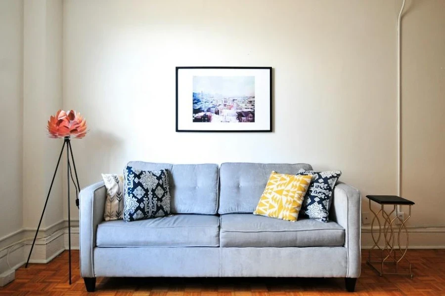 Gray loveseat with patterned accent cushions