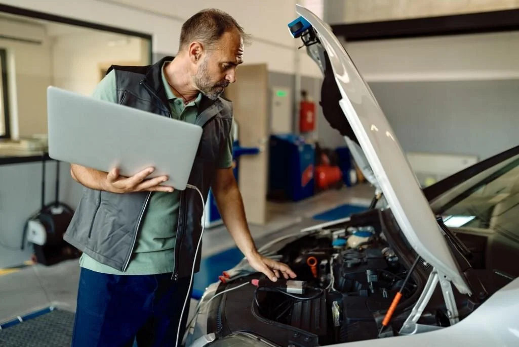 an engineer uses a Laptop for Car Tuning