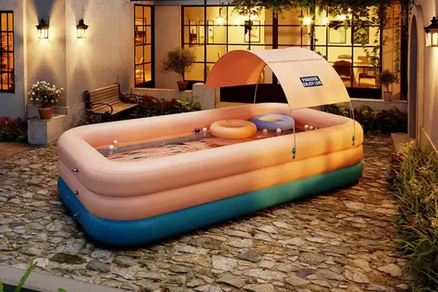 Large blue and orange paddling pool with parasol over top