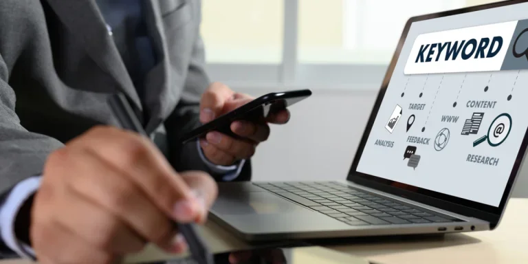 Person sitting in front of a laptop with ‘keyword’ written inside of a search box