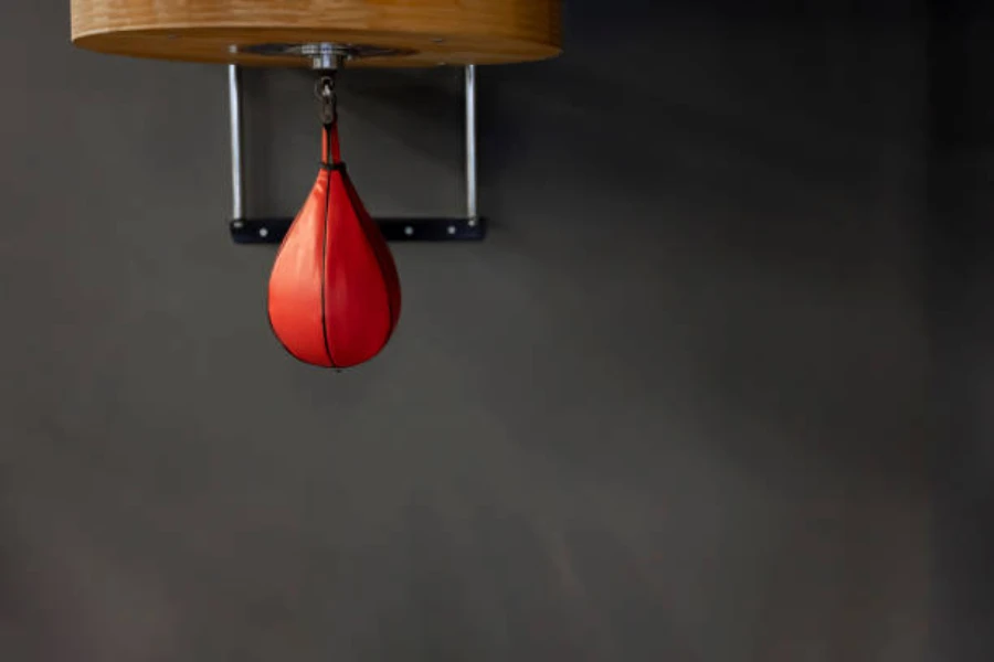Red speed bag hanging from a secure mount on a wall