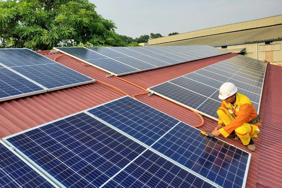 Solar technician conducting maintenance on solar panels